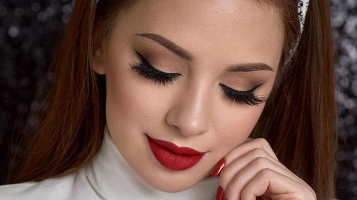 Bold lip color and nude eyes would help you ace the wedding look