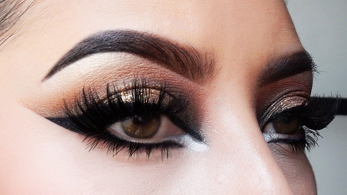 Brown smokey eye makeup with a hint of glitter and neutral face