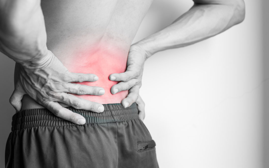 Athletic man's back pain isolated in black and white