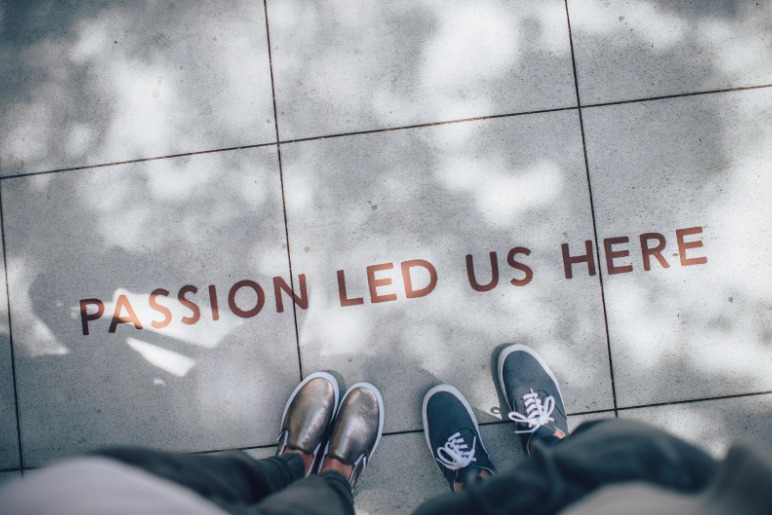 A picture of the words “passion led us here” on the sidewalk, to show how Jerome Karam followed his passions